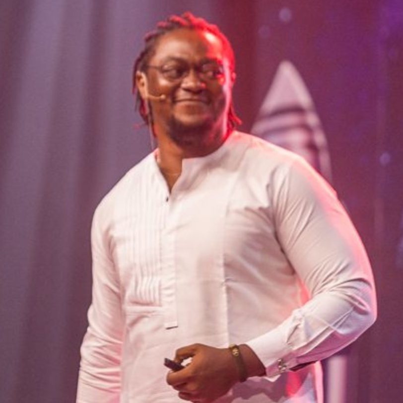 On stage, speaking at an event
